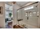 Modern bathroom with a glass shower and seating, and a bedroom view through the doorway at 1006 James Island Ave., North Myrtle Beach, SC 29582