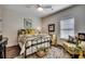 Cozy bedroom with a decorative bed frame, comfortable chair, and plenty of natural light at 1006 James Island Ave., North Myrtle Beach, SC 29582