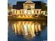 Waterfront home exterior with inviting patio and serene lake views at night at 1006 James Island Ave., North Myrtle Beach, SC 29582