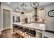 Modern kitchen features a large island with seating, stainless steel appliances, and stylish pendant lighting at 1006 James Island Ave., North Myrtle Beach, SC 29582
