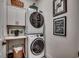 Convenient laundry area with stacked washer and dryer, built-in cabinets, and decorative accents at 1006 James Island Ave., North Myrtle Beach, SC 29582
