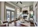 Cozy living room with a fireplace, shiplap accent wall, and views of the water at 1006 James Island Ave., North Myrtle Beach, SC 29582