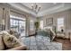 Bedroom with water views, tray ceiling, and an elegant chandelier at 1006 James Island Ave., North Myrtle Beach, SC 29582