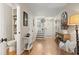 Hallway view with hardwood floors leading to a staircase and a bathroom at 1024 Stanton Pl. # 1024, Myrtle Beach, SC 29579