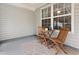 Cozy screened porch with wood chairs and outdoor rug at 1024 Stanton Pl. # 1024, Myrtle Beach, SC 29579
