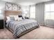 Relaxing main bedroom with a large bed, soft carpet, and plenty of natural light from two windows at 1174 Oak Meadow Dr., Conway, SC 29526