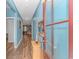 Inviting hallway with wood floors and blue walls, leading to a bright, open living space at 1119 Maxwell Dr., Little River, SC 29566