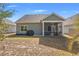 Charming backyard featuring a screened porch, well-manicured lawn, and privacy fence at 1186 Pyxie Moss Dr., Little River, SC 29566