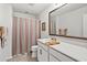 Bright bathroom with a large mirror, neutral color palette, and decorative towels at 1186 Pyxie Moss Dr., Little River, SC 29566