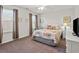 Comfortable bedroom with natural light, white furniture, and seashell-themed bedding at 1186 Pyxie Moss Dr., Little River, SC 29566