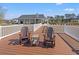 Community deck with rocking chairs and a view of the clubhouse and other amenities at 1186 Pyxie Moss Dr., Little River, SC 29566