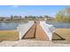 Community fishing dock extending into a serene lake with homes in the background at 1186 Pyxie Moss Dr., Little River, SC 29566