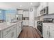 Modern kitchen featuring stainless steel appliances, white cabinets, and an island at 1186 Pyxie Moss Dr., Little River, SC 29566