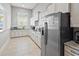Bright kitchen with white cabinets, stainless steel appliances and tile flooring at 1186 Pyxie Moss Dr., Little River, SC 29566