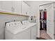 Well-equipped laundry room with modern washer and dryer and ample storage cabinets at 1186 Pyxie Moss Dr., Little River, SC 29566