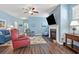 Cozy living room featuring a fireplace, ceiling fan, and hardwood floors at 1186 Pyxie Moss Dr., Little River, SC 29566