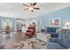 Open concept living room with view of kitchen and dining area with white kitchen cabinets at 1186 Pyxie Moss Dr., Little River, SC 29566