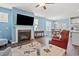 Cozy living room with fireplace, ceiling fan, and view of dining area and kitchen at 1186 Pyxie Moss Dr., Little River, SC 29566