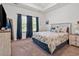 Comfortable main bedroom featuring beach themed decor, plenty of natural light, and carpeted floors at 1186 Pyxie Moss Dr., Little River, SC 29566