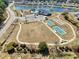 Aerial view showcasing tennis courts, a pool and beautifully maintained landscaping at 1186 Pyxie Moss Dr., Little River, SC 29566