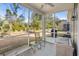 Inviting screened porch featuring outdoor furniture and views of the expansive backyard at 1186 Pyxie Moss Dr., Little River, SC 29566