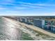 Aerial view of oceanfront condos, beach, and coast offering a picturesque scene of coastal living at 1210 N Waccamaw Dr. # 1507, Murrells Inlet, SC 29576