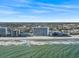 Breathtaking aerial view of the condos, the ocean, and coast, offering the perfect blend of relaxation and adventure at 1210 N Waccamaw Dr. # 1507, Murrells Inlet, SC 29576