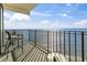 This unit features a private balcony with stylish seating and a table to take in the panoramic ocean views at 1210 N Waccamaw Dr. # 1507, Murrells Inlet, SC 29576