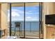 Balcony with seating overlooking the ocean through sliding glass doors at 1210 N Waccamaw Dr. # 1507, Murrells Inlet, SC 29576