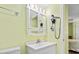 Bright bathroom features a white vanity, mirrored cabinet, and a wall-mounted hair dryer at 1210 N Waccamaw Dr. # 1507, Murrells Inlet, SC 29576