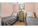 Cozy bedroom with twin beds, wood floors, and a dresser with a decorative mirror above at 1210 N Waccamaw Dr. # 1507, Murrells Inlet, SC 29576