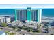 Aerial view of a multi-story hotel with ocean views and a parking garage at 1210 N Waccamaw Dr. # 1507, Murrells Inlet, SC 29576