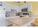 Bright kitchen features white cabinets and a breakfast bar at 1210 N Waccamaw Dr. # 1507, Murrells Inlet, SC 29576