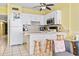 Bright kitchen features white cabinets, stainless steel microwave, and bar seating at 1210 N Waccamaw Dr. # 1507, Murrells Inlet, SC 29576