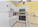Bright kitchen with white cabinets, modern appliances, and tile flooring at 1210 N Waccamaw Dr. # 1507, Murrells Inlet, SC 29576