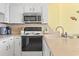 A cozy kitchen features white cabinetry and modern appliances at 1210 N Waccamaw Dr. # 1507, Murrells Inlet, SC 29576