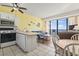 Cozy living room open to the kitchen with bar seating and balcony access at 1210 N Waccamaw Dr. # 1507, Murrells Inlet, SC 29576