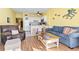 Open-concept living area and kitchen with bar seating and ocean-themed decor at 1210 N Waccamaw Dr. # 1507, Murrells Inlet, SC 29576