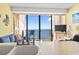 Comfortable living area with access to a private balcony overlooking the ocean at 1210 N Waccamaw Dr. # 1507, Murrells Inlet, SC 29576