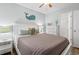 Comfortable bedroom showcases a bed, wooden floors, and a doorway to an ensuite bathroom at 123 N Dogwood St. # 107, Garden City Beach, SC 29576