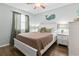 Bright bedroom with hardwood floors, a large window, and a comfortable bed at 123 N Dogwood St. # 107, Garden City Beach, SC 29576