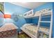 Charming bedroom features a bunk bed and colorful coastal-themed bedding at 123 N Dogwood St. # 107, Garden City Beach, SC 29576