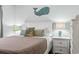 Inviting bedroom features a white frame bed and a stylish whale decoration on the wall at 123 N Dogwood St. # 107, Garden City Beach, SC 29576