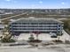 Beautiful exterior view of the multi-level condo building, parking, and surrounding green spaces at 123 N Dogwood St. # 107, Garden City Beach, SC 29576