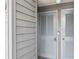 Light blue front door with horizontal slats and gray wood paneled wall at 123 N Dogwood St. # 107, Garden City Beach, SC 29576