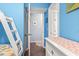 Hallway featuring a bunk bedroom, cabinet, and a doorway to the main living area at 123 N Dogwood St. # 107, Garden City Beach, SC 29576