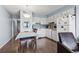 Kitchen and dining area featuring white cabinets and hardwood floors at 123 N Dogwood St. # 107, Garden City Beach, SC 29576