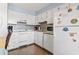Bright white kitchen with mosaic backsplash, hardwood floors, and modern appliances at 123 N Dogwood St. # 107, Garden City Beach, SC 29576