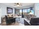 Cozy living room with blue accents, beachy wall decor, and balcony access at 123 N Dogwood St. # 107, Garden City Beach, SC 29576
