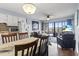 Living room featuring a dining table, flatscreen television, and access to balcony at 123 N Dogwood St. # 107, Garden City Beach, SC 29576